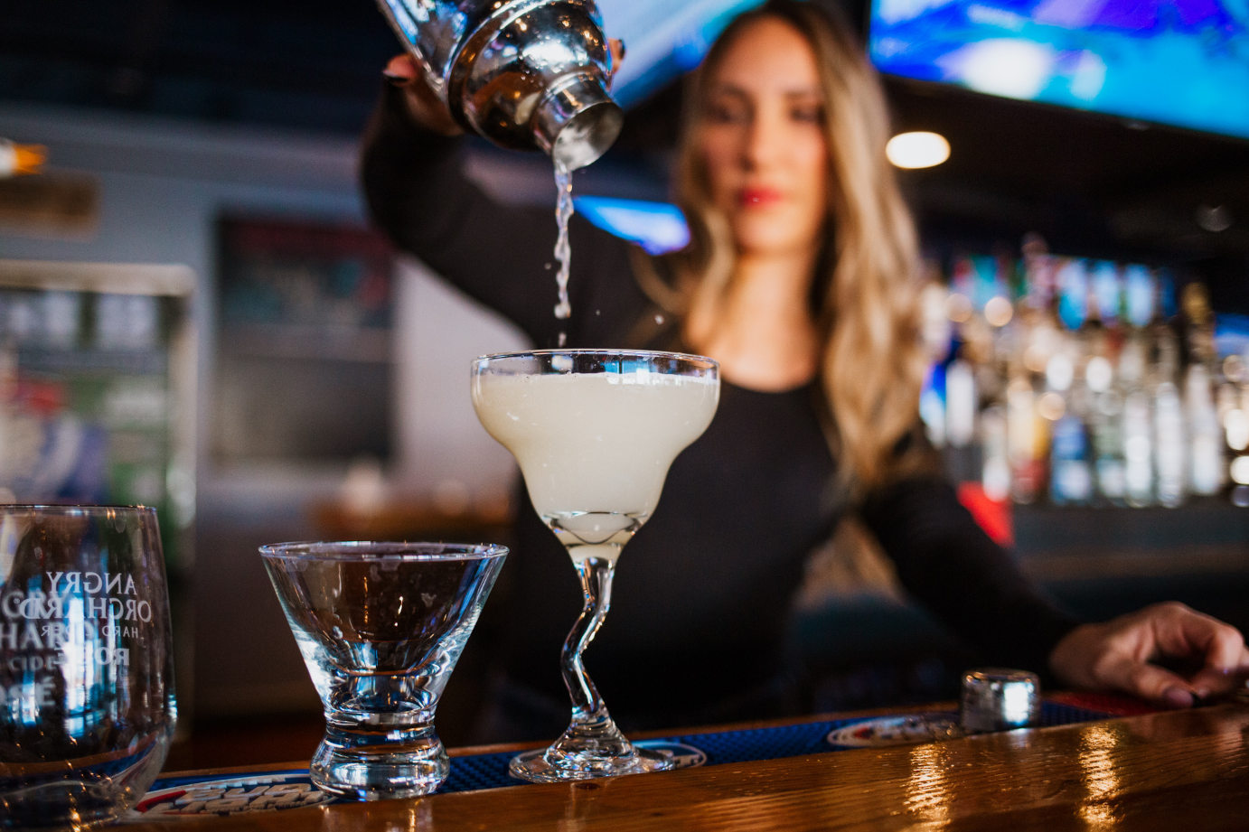 Staff member pouring cocktail